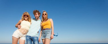 Dostluk mutluluk yaz tatil kavramı. Arkadaşlar çocuk iki kız eğleniyor açık gökyüzü karşı güneş gözlüğü grubu