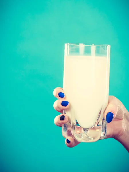 Healthy drinks, good nutrition, dairy products concept. Woman hand holding glass of milk