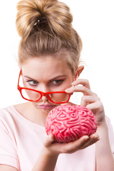 Funny silly weird woman in eyeglasses holding brain having something on mind, thinking of new concepts and ideas.