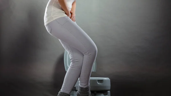 Sick woman with hands holding pressing her crotch lower abdomen in front of toilet bowl. Medical problems, incontinence, health care concept — Stock Image Sick Woman Hands Holding Pressing Her Crotch Lower Abdomen Front Royalty Free Stock Photos