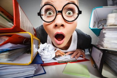 Çalışmalar sırasında yüz ifadeleri. Belgeler ve dosyalar Office çevrili deli düşünceli muhasebeci işkadını.