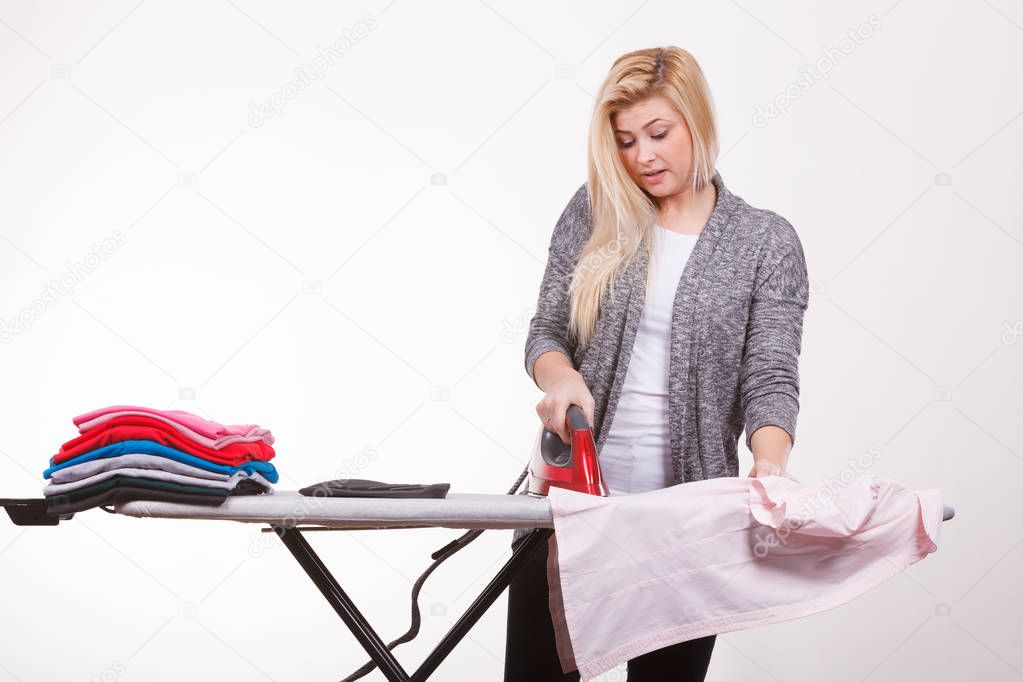 Household duties, domestic chores concept. Happy woman holding iron about to do ironing