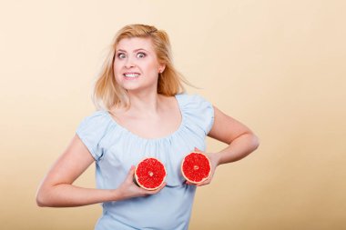 Sağlıklı beslenme, gıda vitamin tam yenileniyor. Mutlu deli kadın holding tatlı lezzetli narenciye meyve, kırmızı greyfurt meme üzerinde