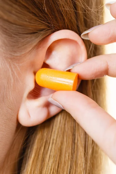 Woman Putting Ear Plugs Her Ears Getting Rid Noise Loud Royalty Free Stock Images