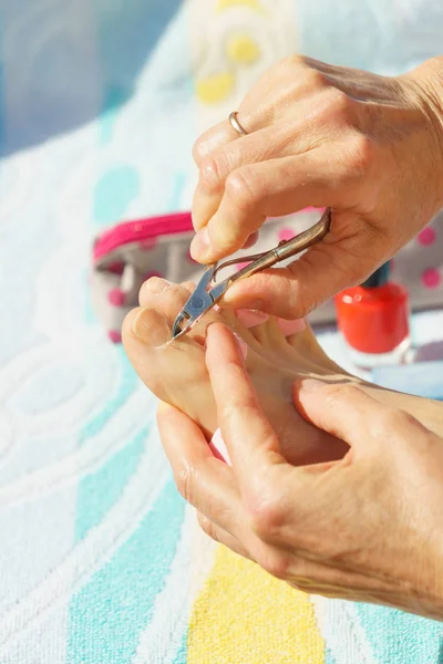 Kadın önce pedikür çivi hazırlanıyor. Tanınmayan erkek kütikül cildi açık tatillerde kırpma.