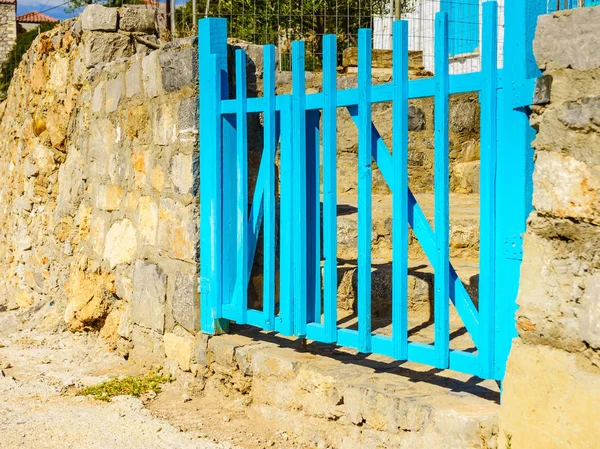 Typical Greek architecture details concept. Blue fence outdoor house during summer weather.