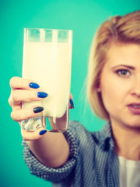 Healthy drinks, good nutrition, dairy products concept. Woman hand holding glass of milk