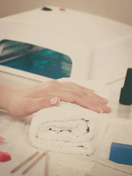 Woman hand on towel, waiting for gel hybrid manicure. Beauty wellness spa treatment concept