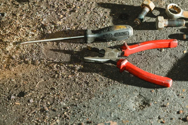 Mechanical automotive fixing engineering industry concept. Pliers, wrench screwdriver on table. Bunch of hand tools in workshop.