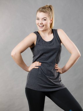 Mutlu kadın siyah kolsuz bluz ve iyi bir ruh hali olan gülümseyen tozluk giyiyor. Spor kıyafeti