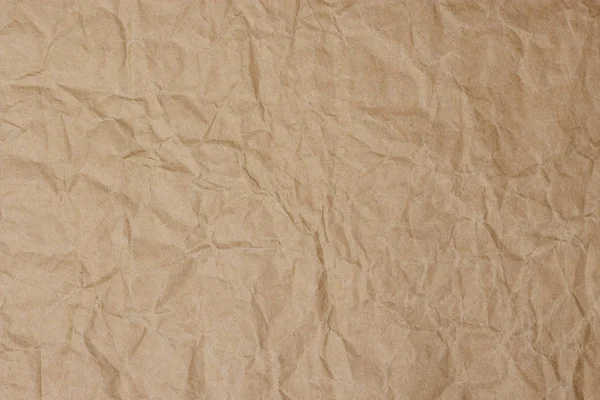 Old vintage crumpled brown page paper texture or background
