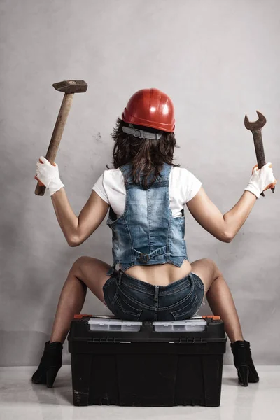 性平等とフェミニズム バックセクシーな女の子のツールボックスにレンチスパナとハンマーを保持に座っている 整備士として働く女性 — ストック写真
