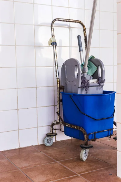 Trolley with bucket full of water and mop. Household or industrial cleaning objects.