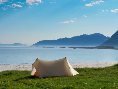Yazın deniz kıyısında çadır. Okyanus kıyısında kamp yapmak. Lofoten takımadaları Norveç. Tatil ve seyahat.