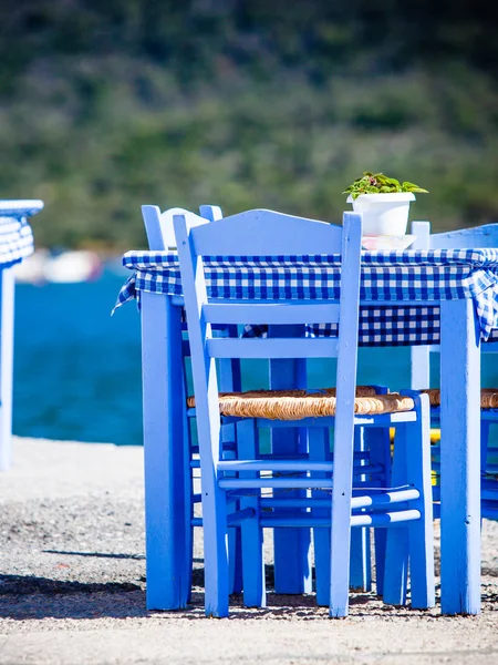 Deniz kenarındaki mavi masa ve sandalyeler deniz kıyısında Yunanistan 'da açık bir kafe restoranı açıyor. Yaz tatili.