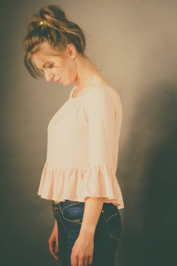 Üzgün depresif endişe dolu anksiyete kadın ayakta seyir aşağı. Görüntü stüdyo çekim tonda.