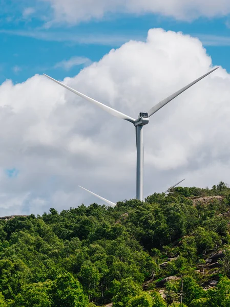 Power generators farm on rocky coast hills, wind turbines in Norway. Renewable eco energy concept.