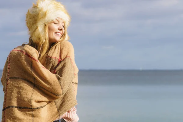10代の女性は秋の天候の間にビーチで屋外で時間を過ごす セーター スカーフ 毛皮の帽子を身に着けて — ストック写真