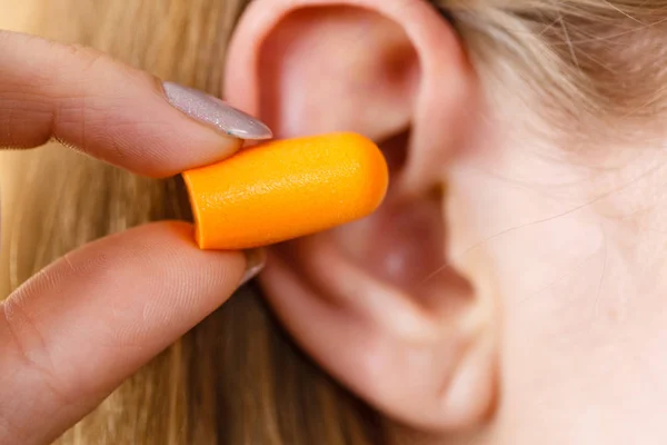 Woman Putting Ear Plugs Her Ears Getting Rid Noise Loud Stock Photo