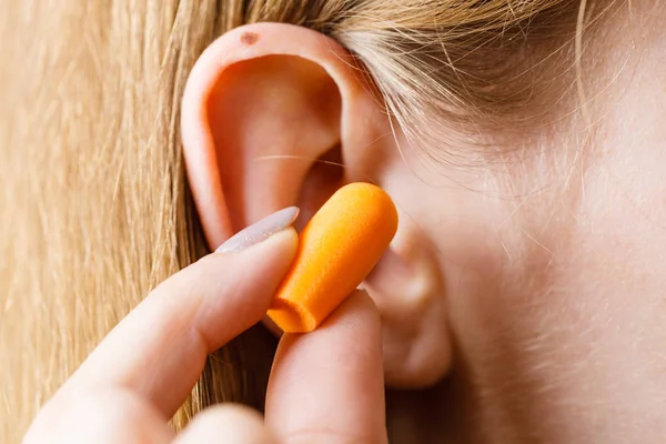 Woman Putting Ear Plugs Her Ears Getting Rid Noise Loud Stock Image