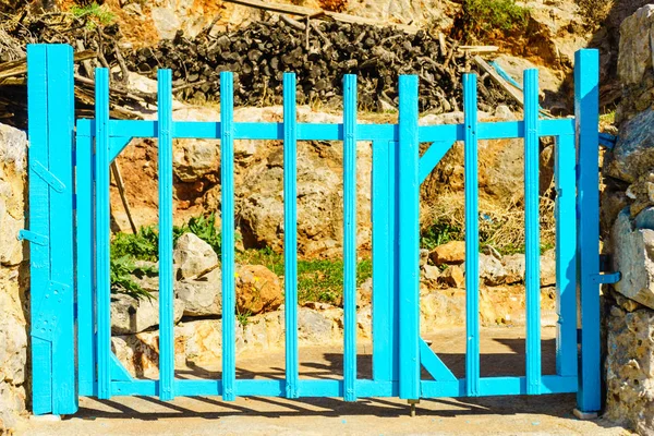 Typical Greek architecture details concept. Blue fence outdoor house during summer weather.