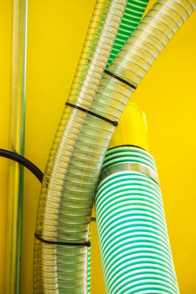 Close up of plastic made corrugated pipes. Agricultural rural machine details concept.