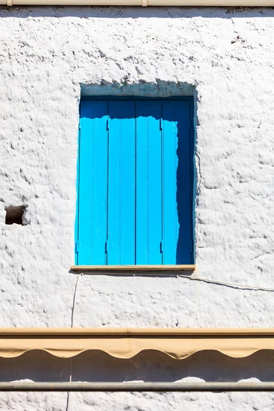 Typical Greek architecture details concept. Blue window shutters on house in Greece.
