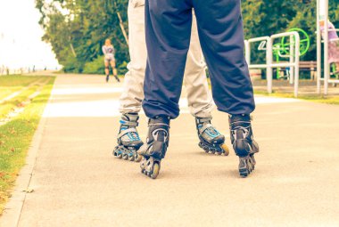 Boş zamanlarında birlikte yaz harcama. Hobi ve yaşam tarzı. Egzersiz ve sağlıklı vücut. Paten sürme spor giyim bacaklarda, yakın çekim.