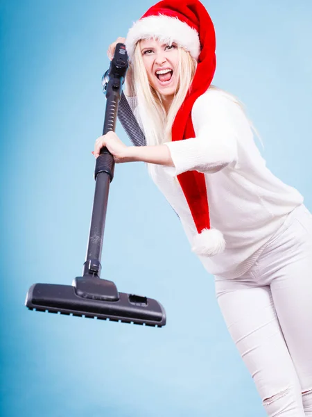 Angry girl in santa helper hat with vacuum cleaner — Stock Photo, Image