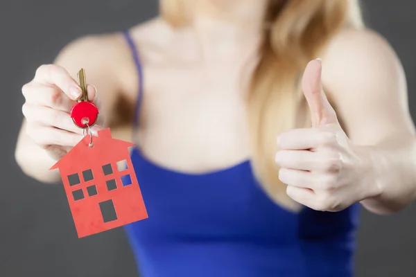 Woman holding key with house symbol — Stock Photo, Image