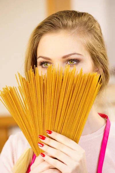 Woman hiding behind long pasta — Stock Photo, Image