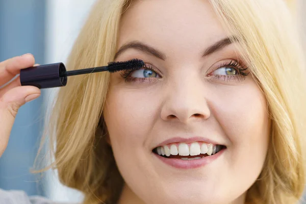 Vrouw met behulp van mascara op haar wimpers — Stockfoto