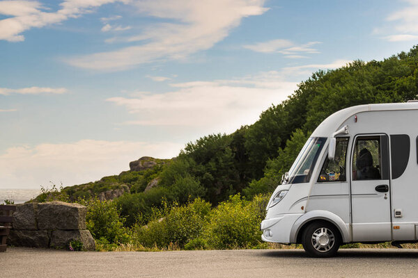 Camper car on coast of Norway with ocean view