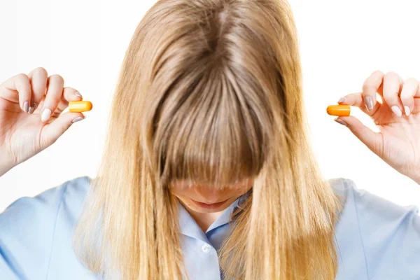 Woman putting earplugs — Stock Photo, Image