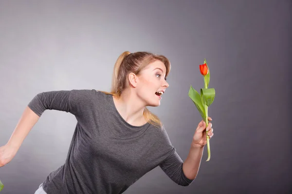 Lekfull tjej att ha kul med blomma tulpan. — Stockfoto