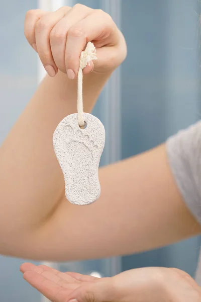 Woman holding pumice stone — Stock Photo, Image