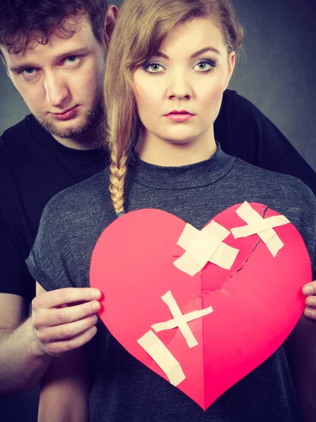 Sad couple holds broken heart. — Stock Photo, Image