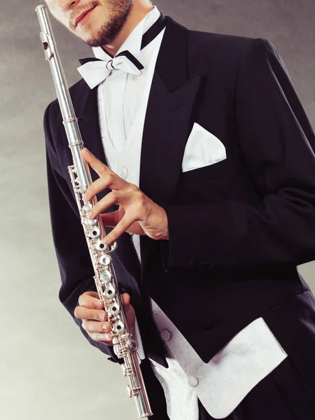 Elegantly dressed musician holding flute — Stock Photo, Image