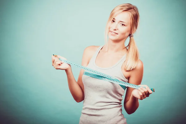 Fitness girl measuring her breasts — Stock Photo, Image