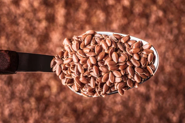 Flax seeds linseed on kitchen spoon — Stock Photo, Image