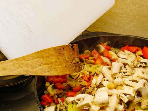 Adding mushrooms to pan vegetables. — Stock Photo, Image