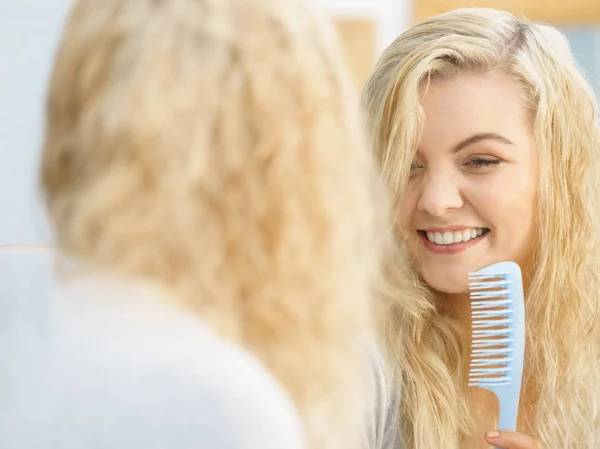 Donna che si prepara in bagno, pettinando i capelli . — Foto Stock