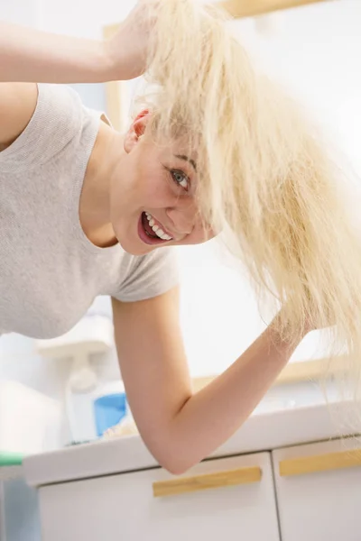 Mulher brincando com cabelo loiro — Fotografia de Stock