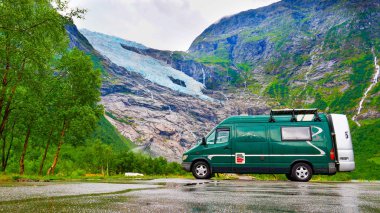 Camper van and Boyabreen Glacier in Norway clipart