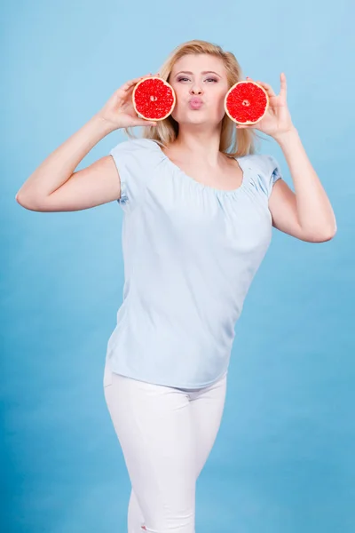 Feliz mujer sonriente sosteniendo pomelo rojo —  Fotos de Stock