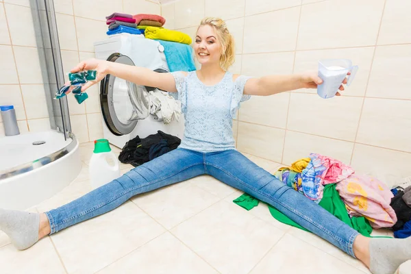 Girl wash laundry with different detergent.
