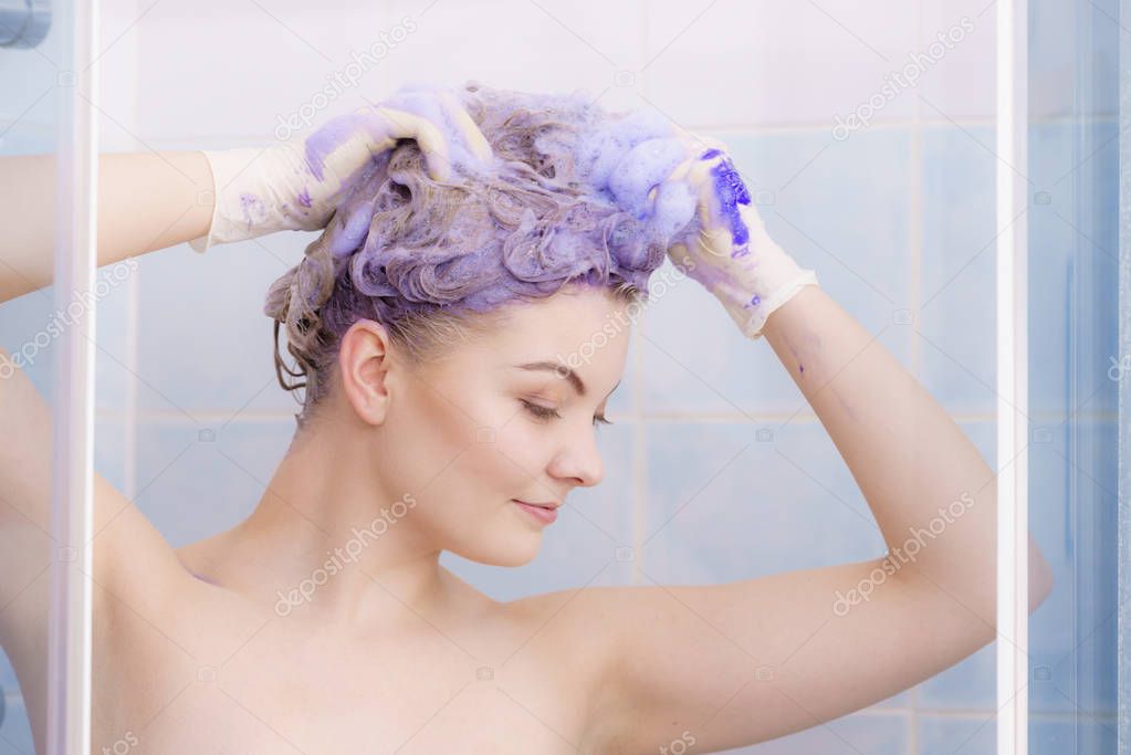 Woman applying toner shampoo on her hair