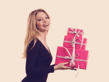 Pembe hediye kutuları yığını tutan kız