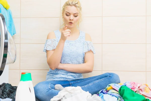 Unhappy woman having a lot of laundry — Stock Photo, Image