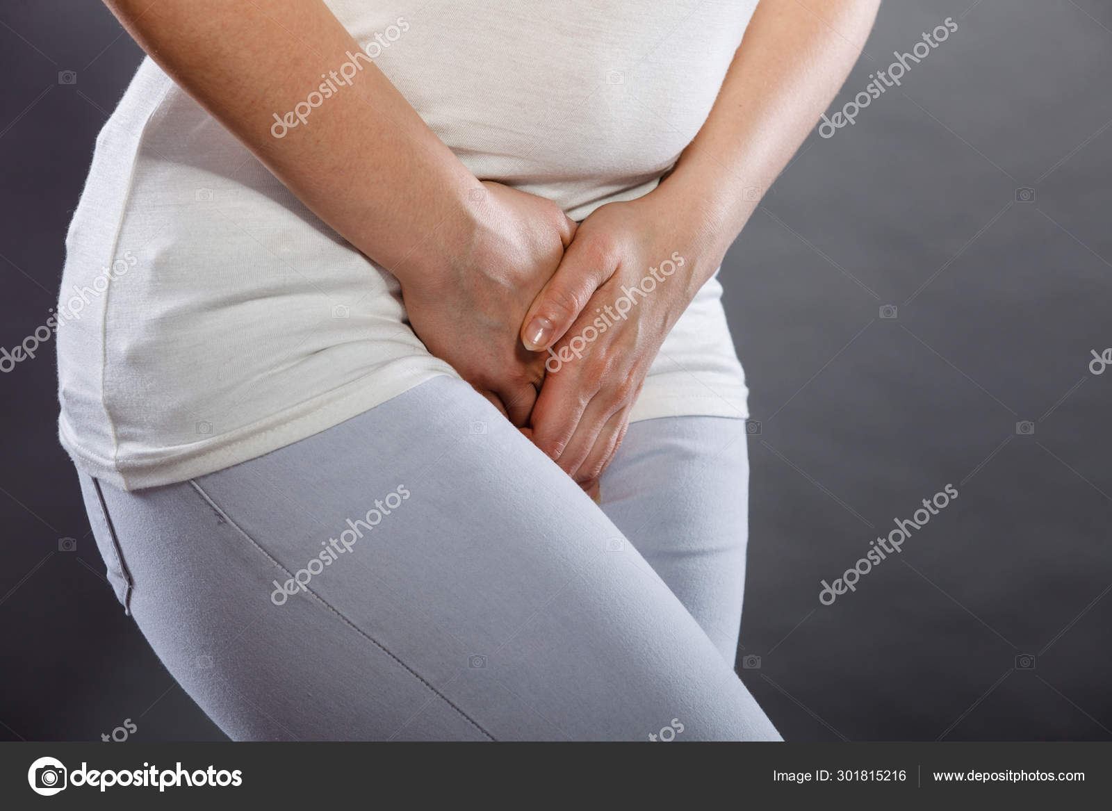 Woman with hands holding her crotch Stock Photo by ©Anetlanda 301815216